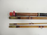 several different types of fishing rods are lined up on a white surface