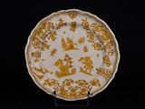 assiette jaune et blanche ornée d'un motif représentant un dragon