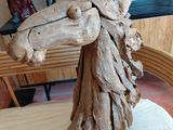 a wooden sculpture of a horse made of wood on a table