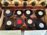 many old records in a wooden box on display