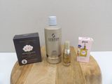 a bottle of lotion, a box of soap, and a box of perfume sitting on a table