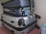 several pieces of luggage stacked on top of each other on a chair