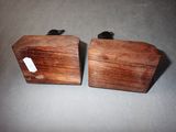 two pieces of wood with a tag on them sitting next to each other