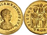a gold coin with an image of a woman and a man on it