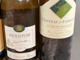 three bottles of wine sitting next to each other on a table