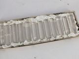 a glass tray with a lot of empty bottles inside of it