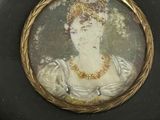 an old picture of a woman wearing a tiable in a black frame