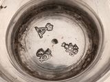a close up of a metal bowl with a design on it