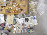 a lot of pins and magnets on the table