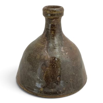 a brown vase that is sitting on a white surface