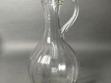 a clear glass pitcher that is sitting on a table