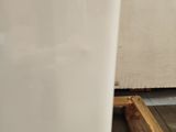 a white vase sitting on a table in a room