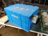 a blue box sitting on a table next to a green bin