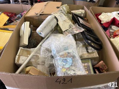 a cardboard box filled with assorted items on a table
