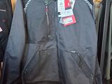 a black jacket hanging on a rack in a store