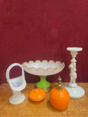 une table sur laquelle se trouvent un bol, des oranges et un bougeoir