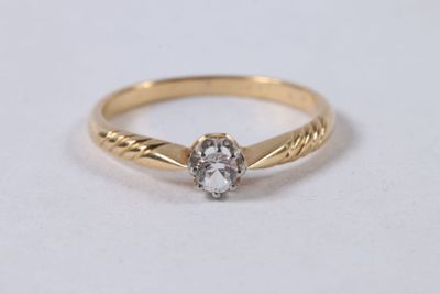 a yellow gold ring with a white diamond in the center
