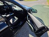 a black car with a gun in the passenger seat