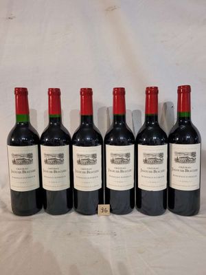 six bottles of red wine lined up in a row on a table