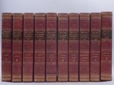 six red books lined up in a row on a white surface