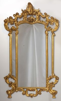 une image d'un miroir encadré d'or accroché à un mur