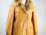 an image of a brown leather jacket with a fur collar on a mannequin