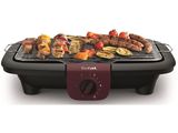 an image of a grill with meats and vegetables cooking on it