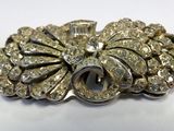 a close up of a brooch with a lot of diamonds on it