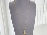 gold plated initial necklace with initial charm on a mannequin