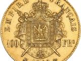 a gold coin with a coat of arms and a crown on it