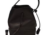 the small bucket bag is black and has a leather handle