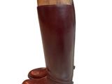 brown leather riding boots with a wooden handle on a white background