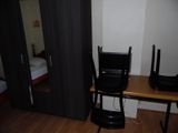 a desk with a laptop and a chair in the room