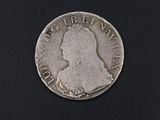 a close up of a coin on a black surface