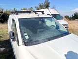 a white car that is parked on the side of the road