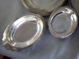 three silver plates sitting on top of a table next to each other