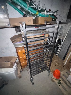 a pile of boxes and a rack in a room