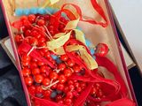 a box with a bunch of red berries inside of it