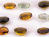 several different colored gems sitting on top of a white surface