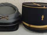 pair of hats sitting on top of each other on a bed