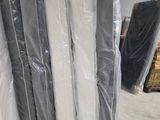 a large stack of mattresses sitting in a warehouse
