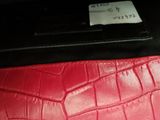 a red wallet with a price tag on it