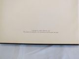 an open book sitting on top of a table covered in white sheets
