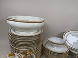a lot of plates and bowls on the table