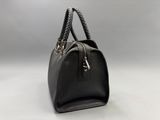 a black leather handbag with braid handles on a white background