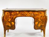 a small wooden table with a floral design on it