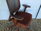 a brown office chair with a brown seat on a carpet