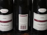 three bottles of wine are lined up on a table