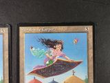 two cards that have a picture of a girl on a flying carpet