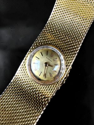 an image of a close up of a wrist watch on a black surface